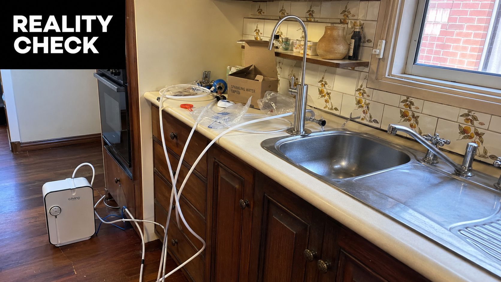 A sparkling water tap system being installed on a kitchen counter with tubing connecting to a floor unit.