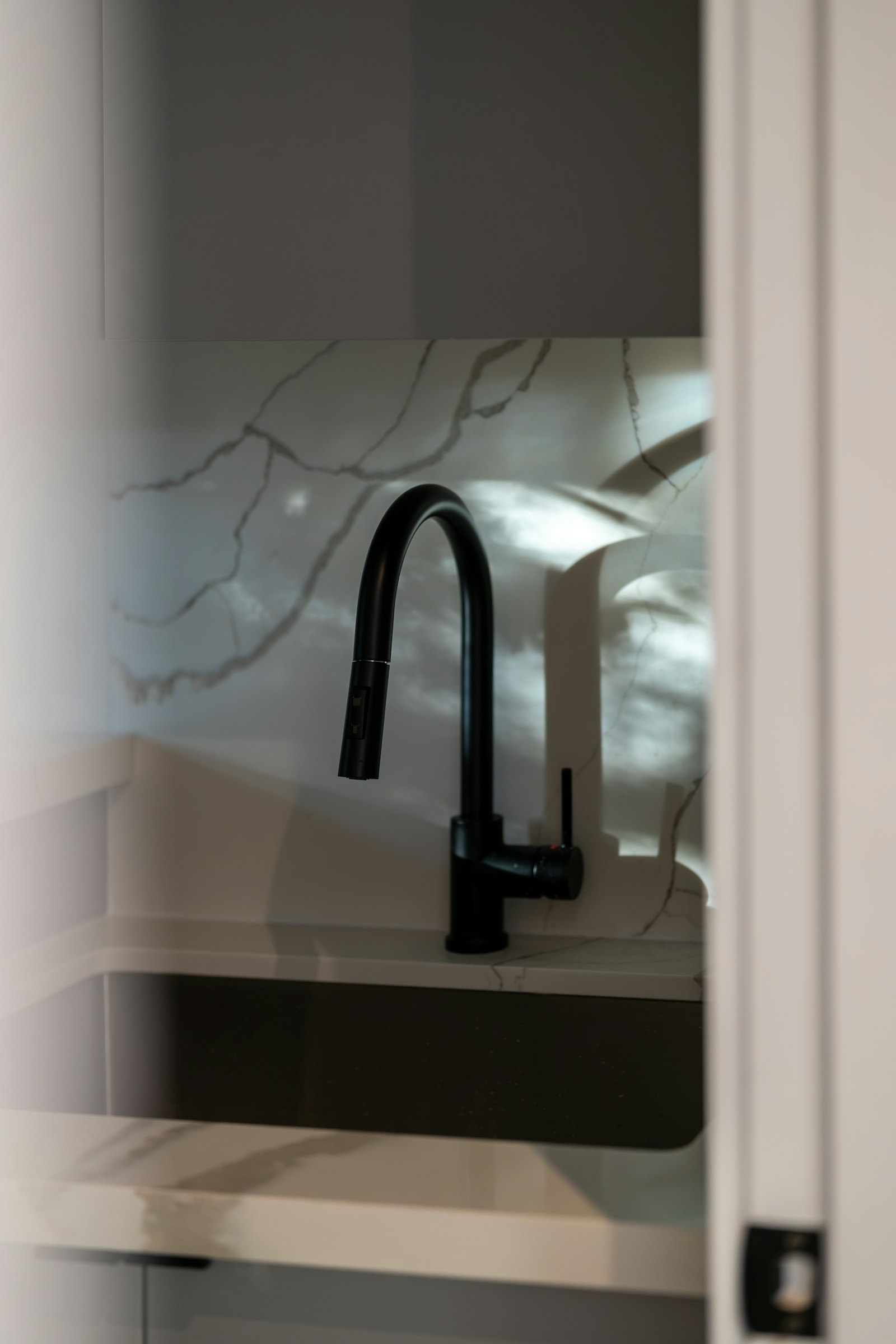 Matte black boiling water tap over a marble benchtop